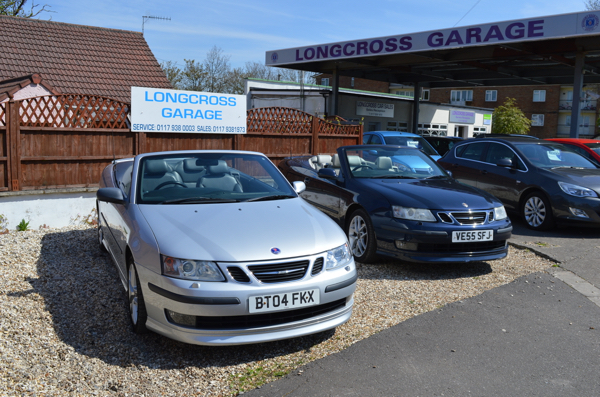A silver Saab at the front of a row of cars under the Longcross canopy