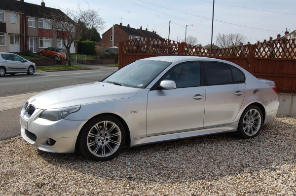 A silver saloon on the gravel forecourt