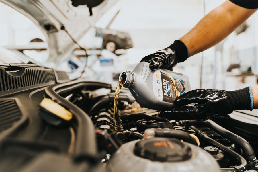 Fresh oil being poured into an engine during a service