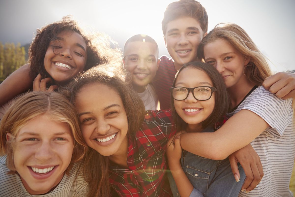 A group of teenage friends smiling together