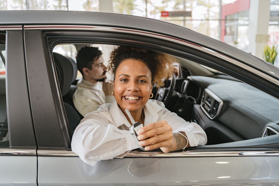 A customer in the driving seat holding up the keys