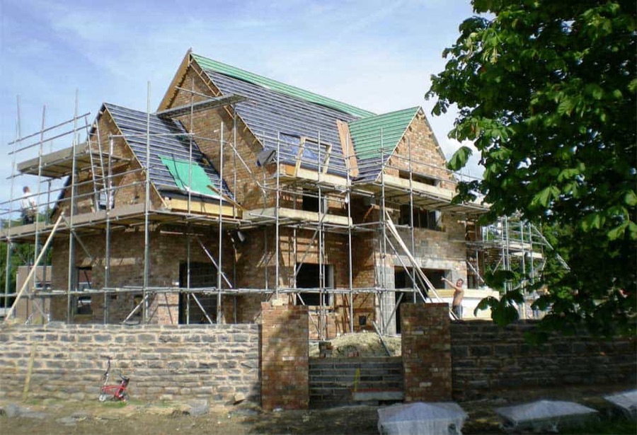 A house undergoing extensive works surrounded in scaffolding