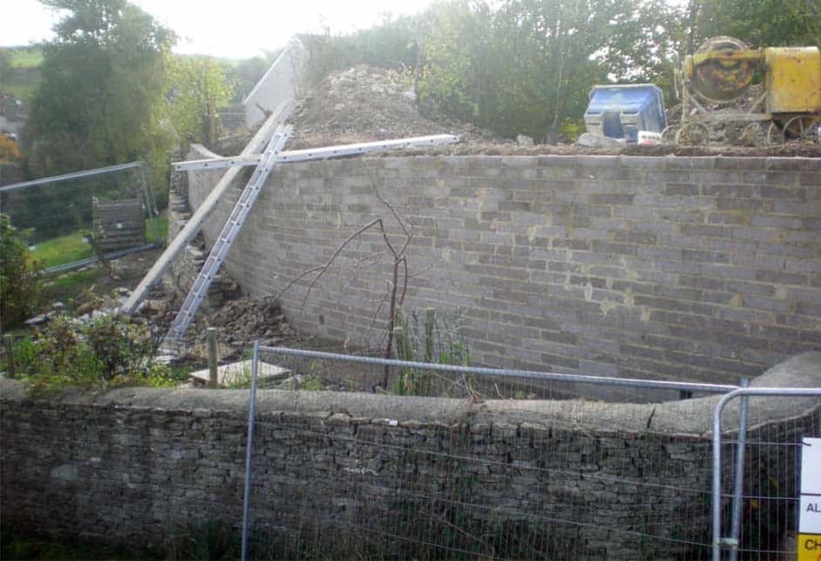 A garden wall being rebuilt