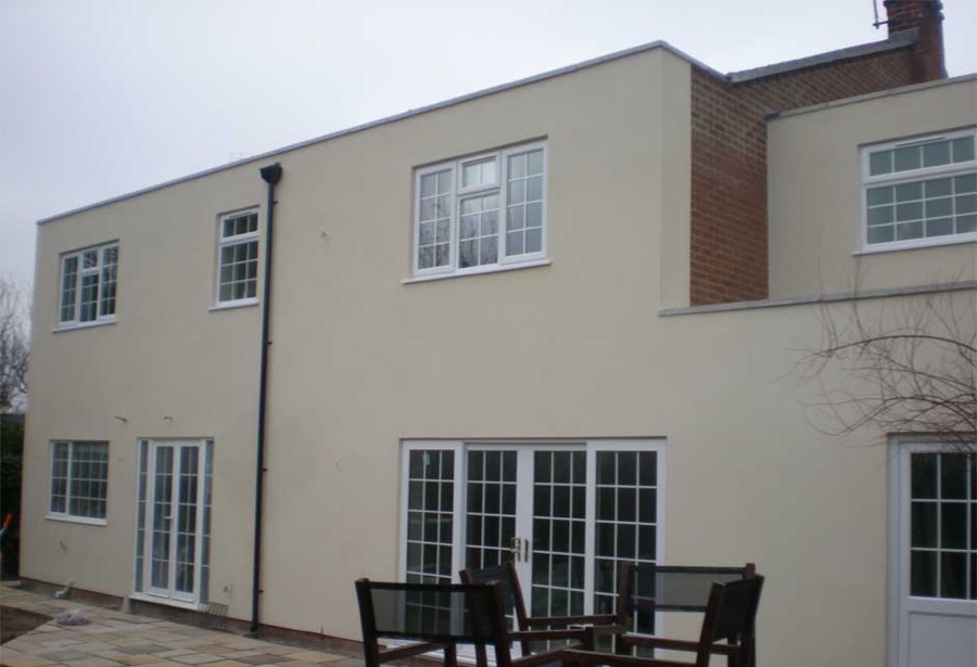 A rendered house with new windows and a patio