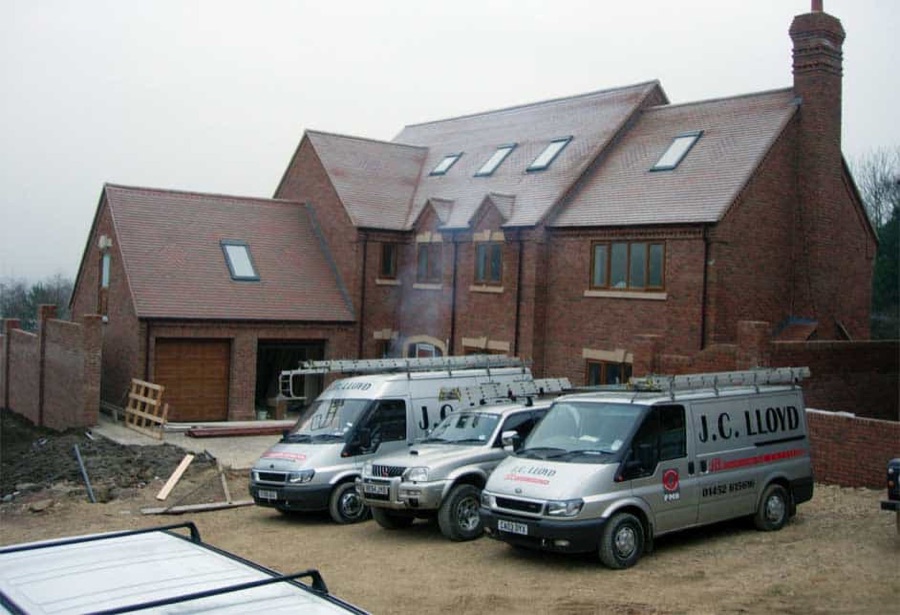 The finished house at Mulberry Gardens, the J C Lloyd vans outside