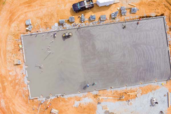 An aerial view of a large new concrete slab on an industrial site