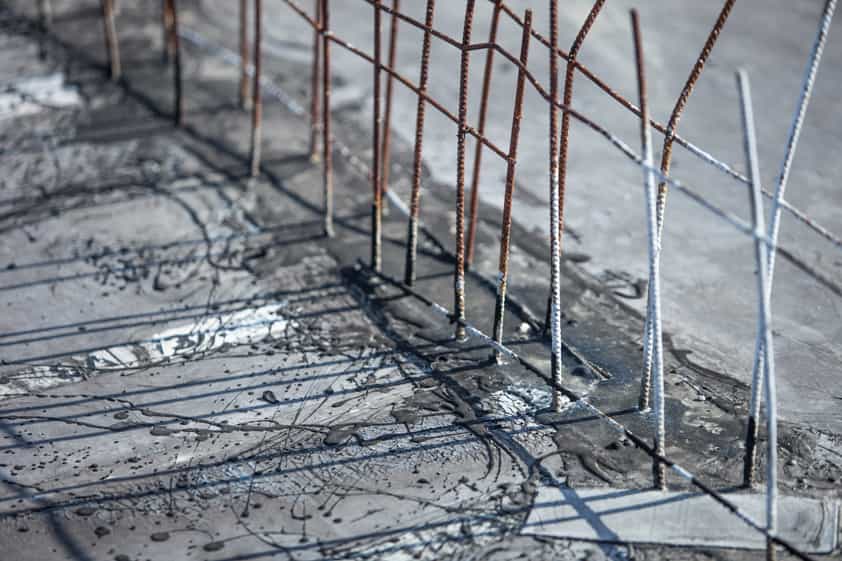 Steel reinforcing bars standing up out of a concrete base