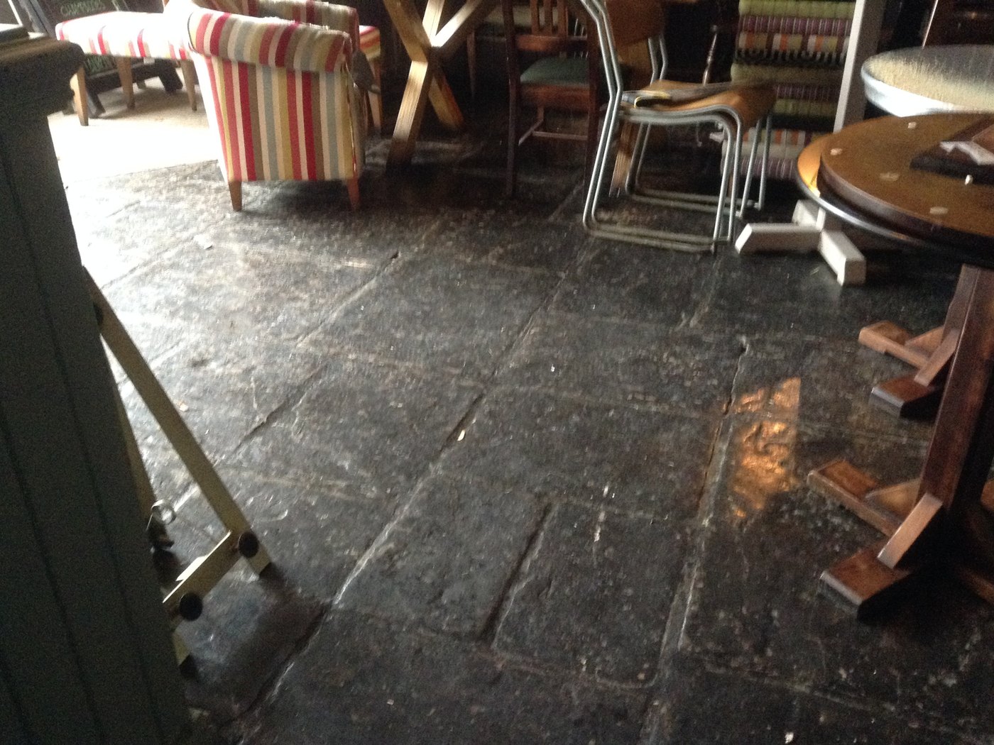 A flagstone floor cleaned by Ashton Cleaning — before