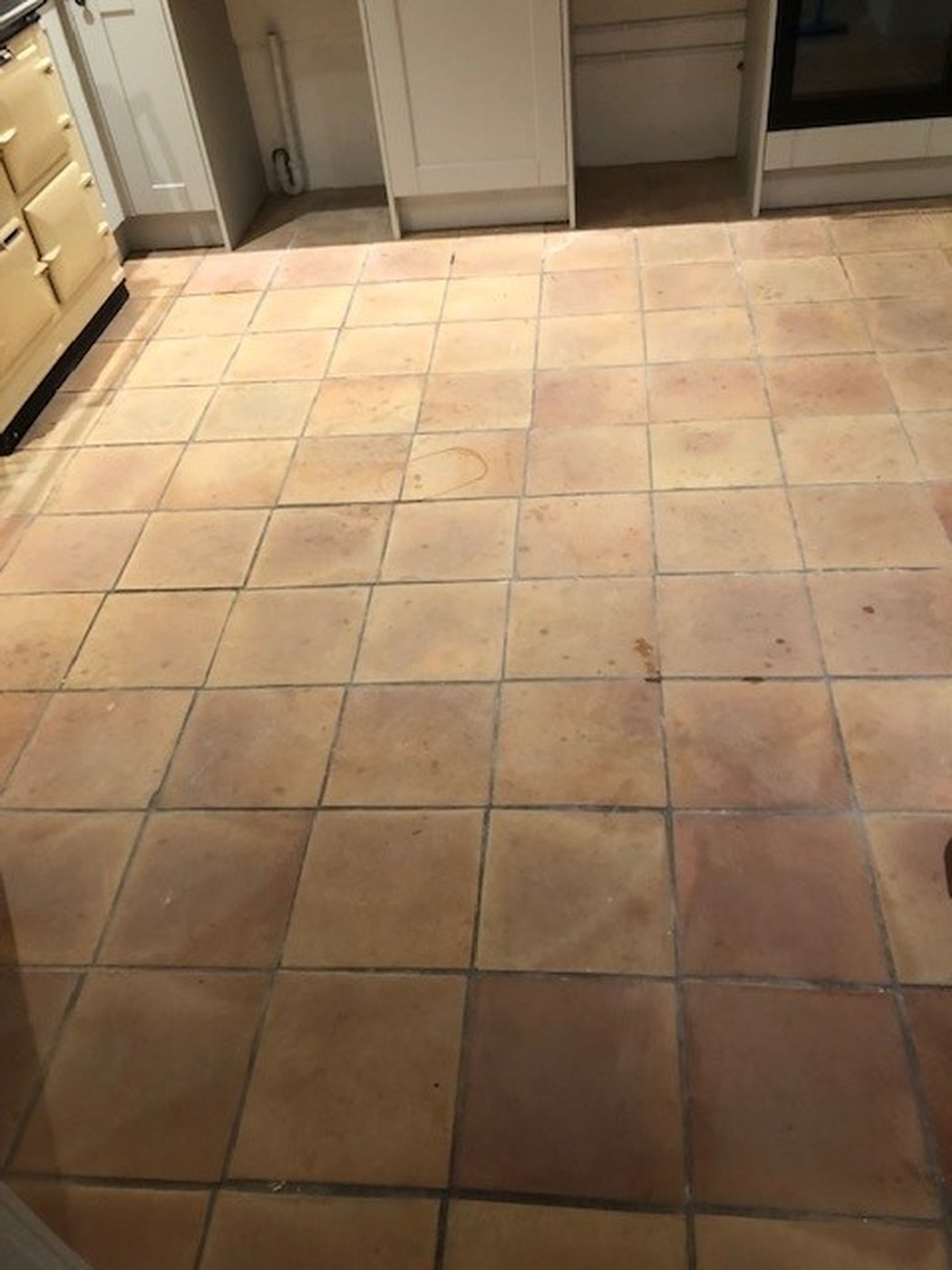 A terracotta floor restored by Ashton Cleaning — before